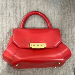Elegant Red Handbag with Gold Accents
